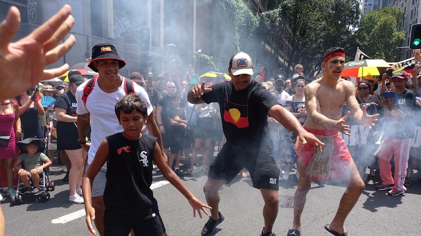 NRL star Latrell Mitchell dances during an Invasion Day protest rally.