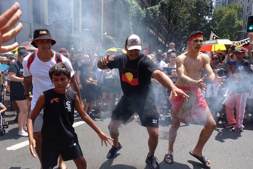 NRL star Latrell Mitchell dances during an Invasion Day protest rally.