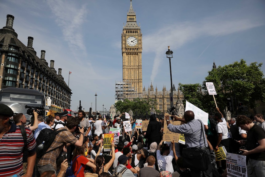 Demonstrators sit in the road in Parliament Square.