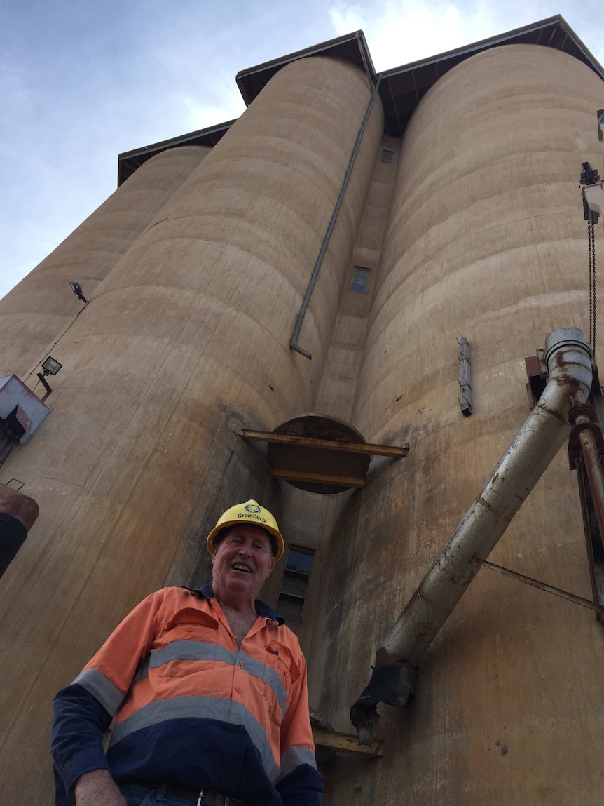 Len 'Squatter' Coffey stands in front of Yaapeet's 1939 grain silos.