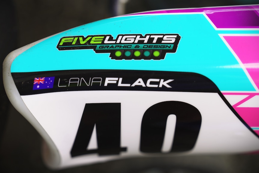 A close-up of Lana Flack's name on a blue and pink go kart.