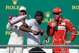 Lewis Hamilton pours champagne on Usain Bolt on the podium at the US Formula One Grand Prix.