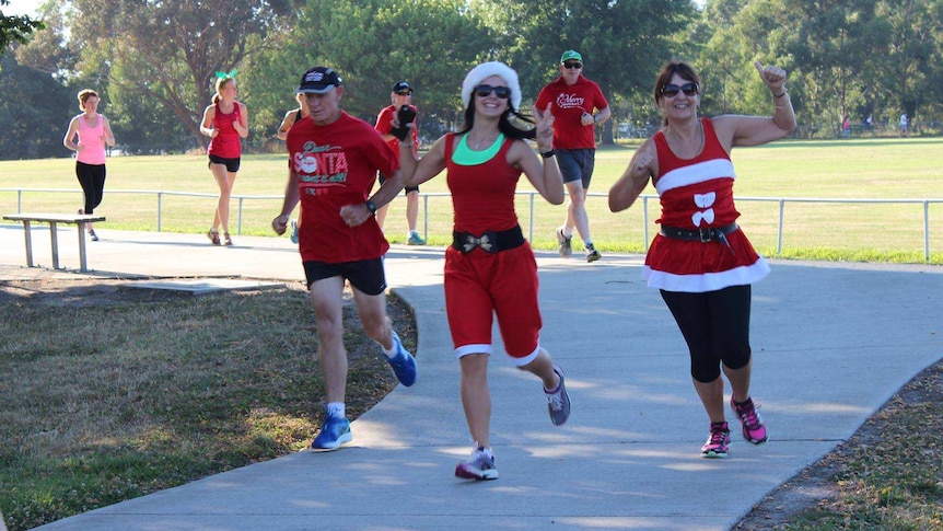 Runners in fancy dress wave