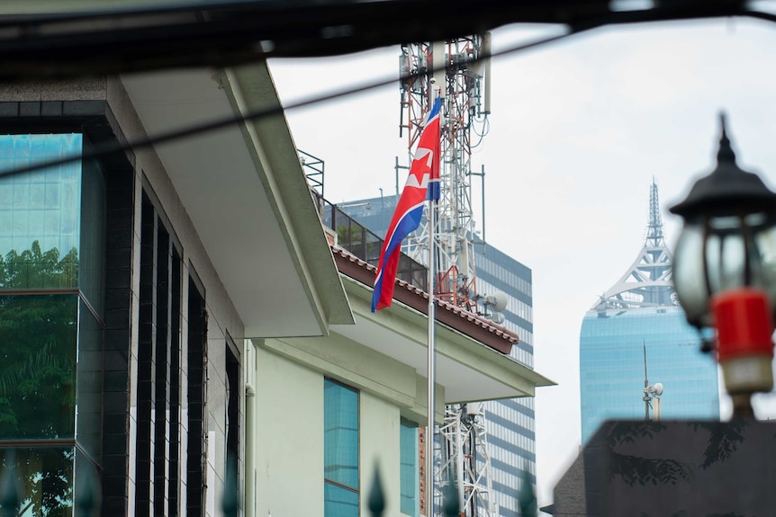 The North Korean flag flying on a flagpole