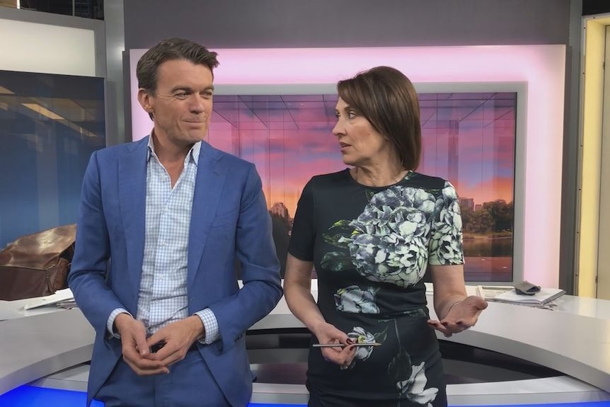 Michael Rowland and Virginia Trioli stand at the news desk.