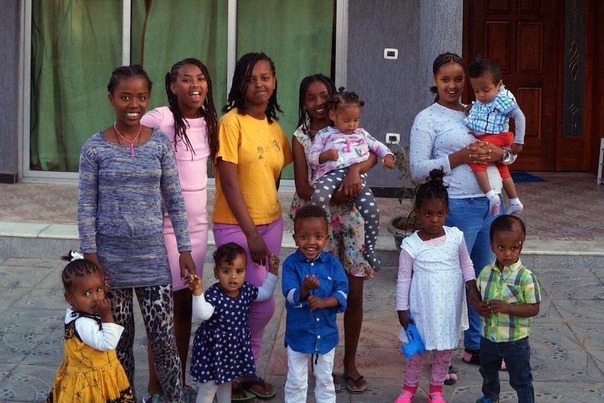 Children stand in front of an orphanage in Ethiopia