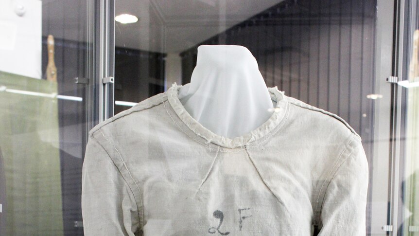 A straitjacket in a glass cabinet.