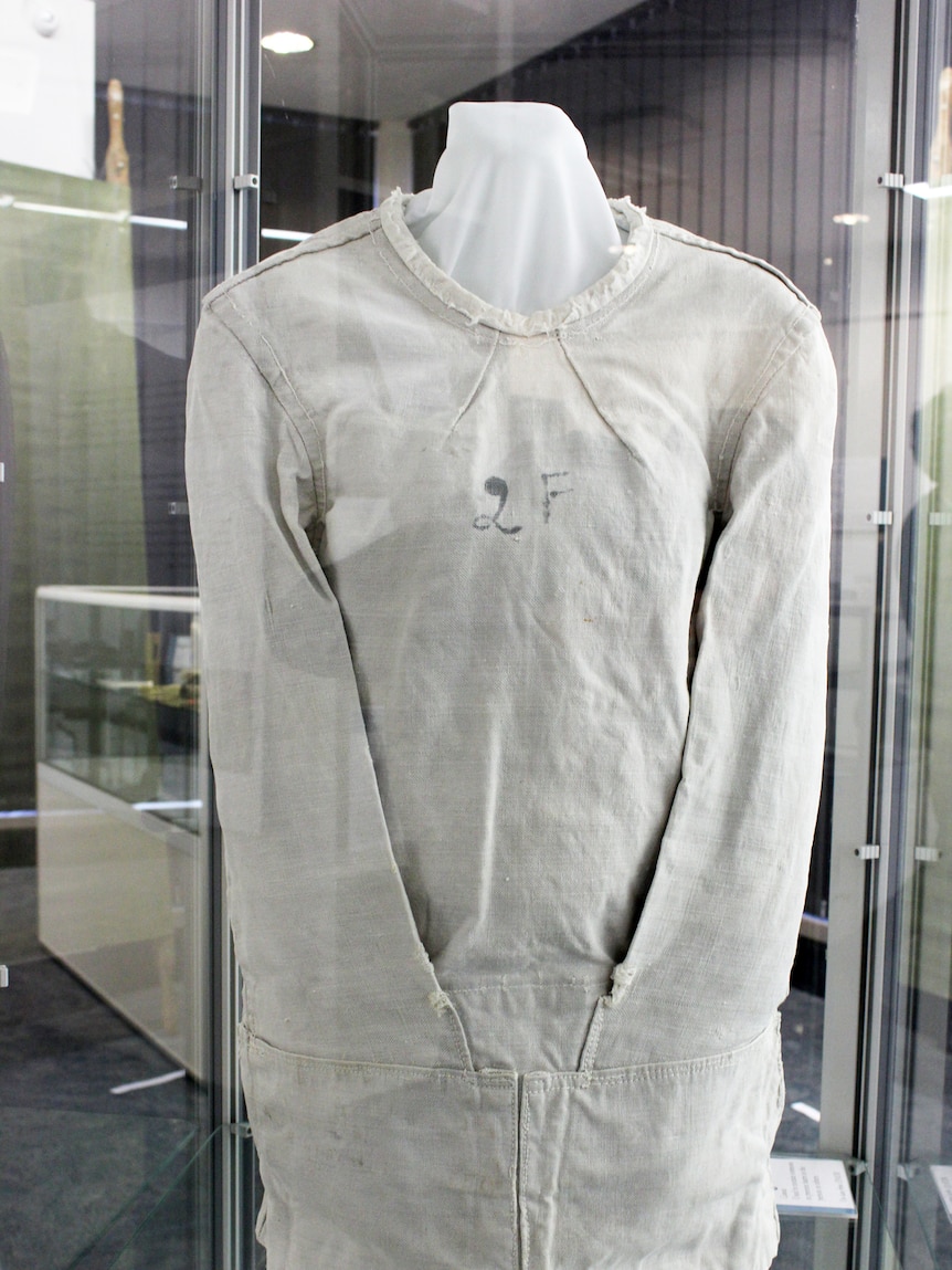 A straitjacket in a glass cabinet.