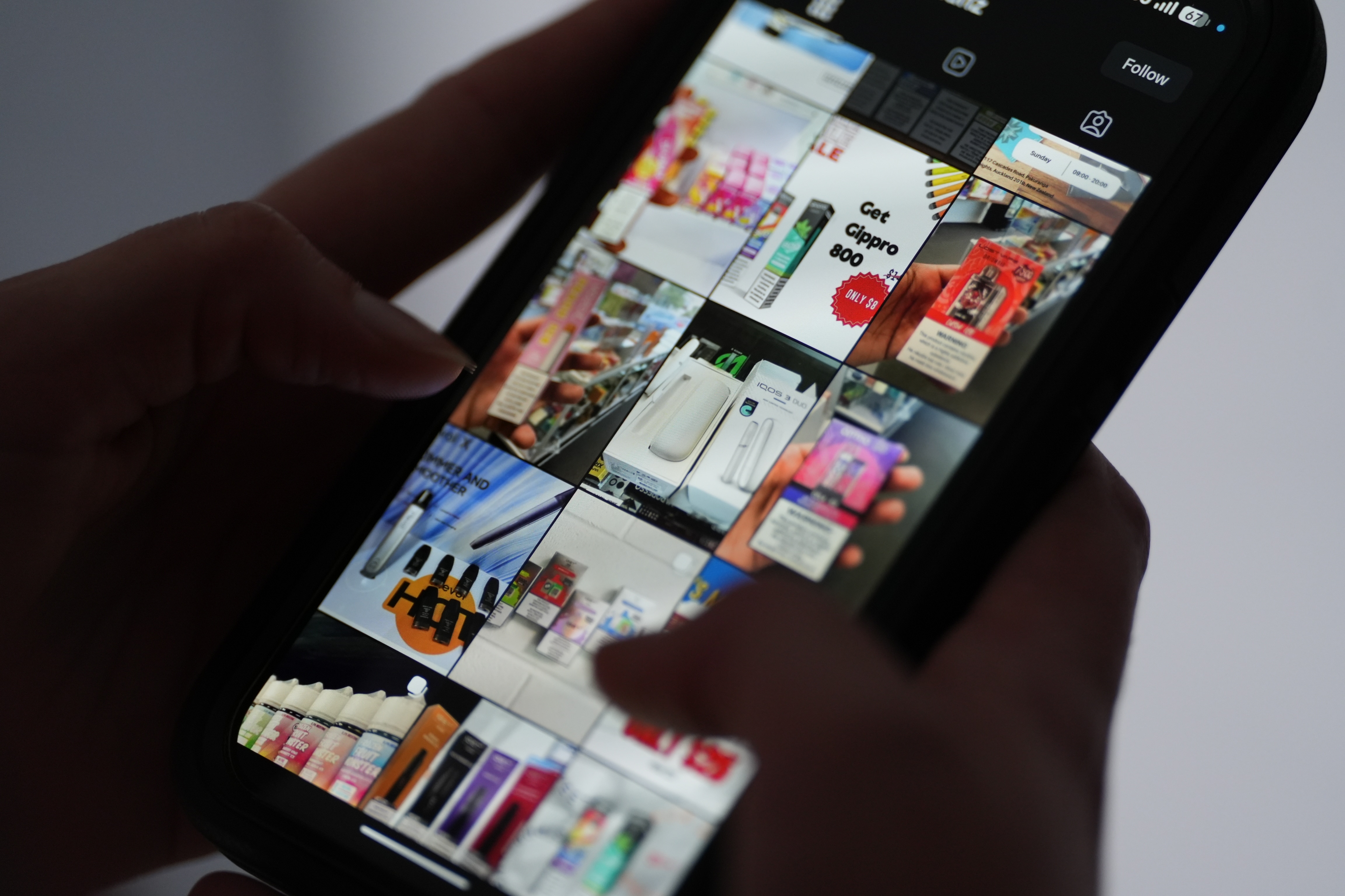 A person scrolling through Instagram stories about vape products on a mobile phone. 