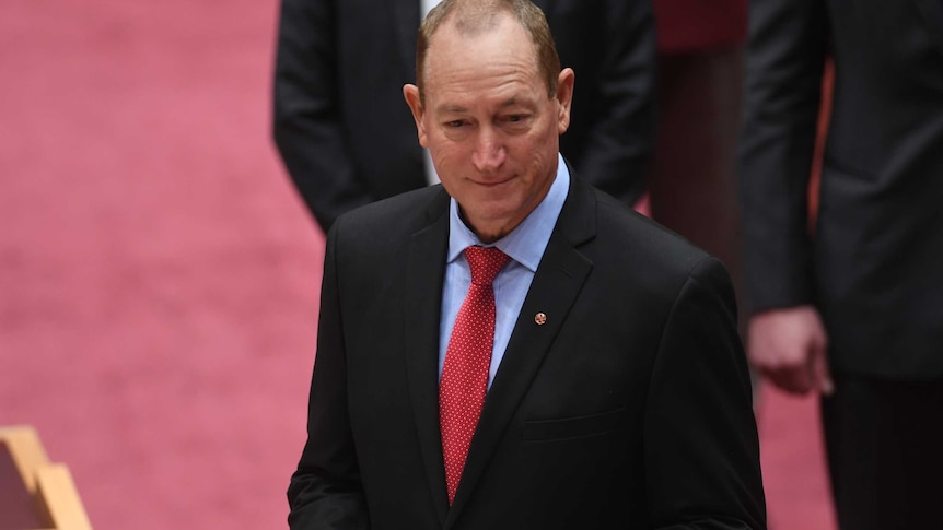 Fraser Anning taking the oath of office in the Senate chamber.