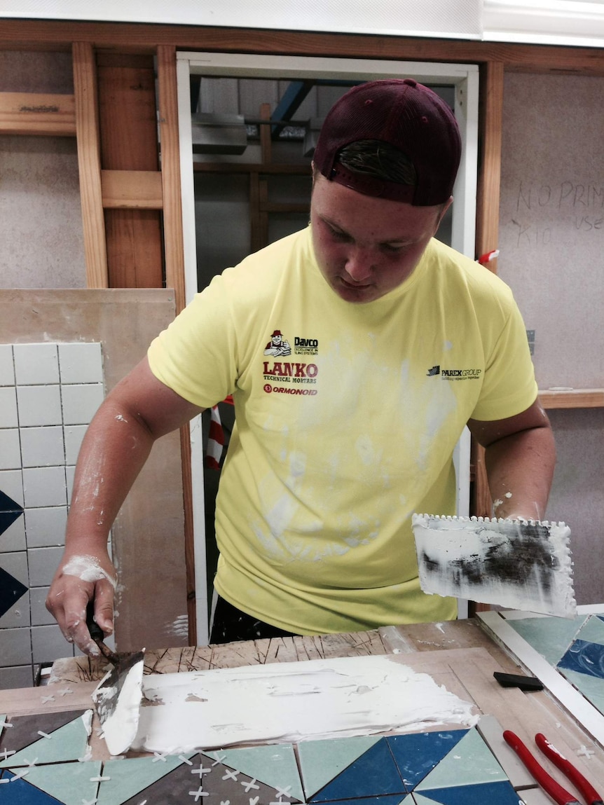 Jarrod Spencer, 14, from Narellan laying out tiles as part of a TAFE trade readiness program.