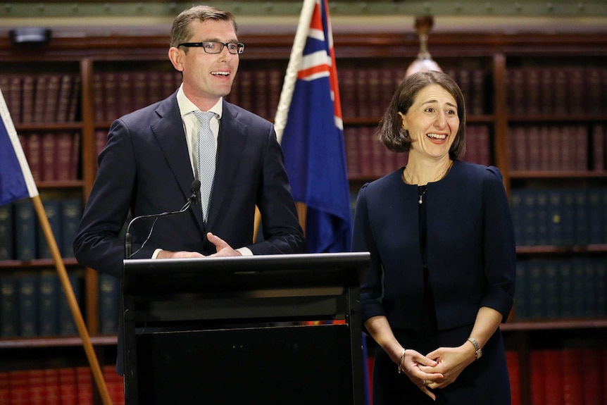 The treasurer and premier standing side by side smiling