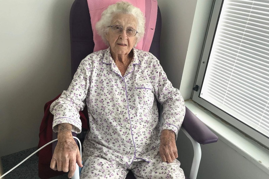 An elderly woman in a hospital room