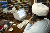 Iranian clergymen work on the website of Iraq's Shiite Muslim Grand Ayatollah Ali Sistani.