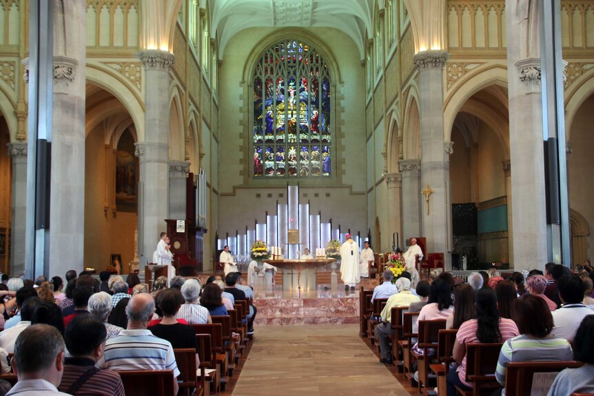 Christmas Day mass at St Mary's Cathedral in Perth, with parishioners lining the pews.