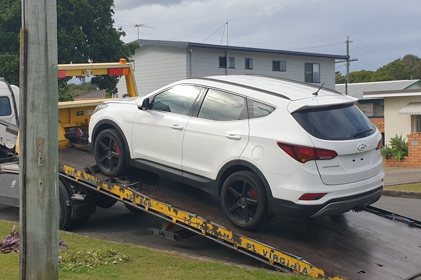 Sue Dunn's white car being returned to her on a tow truck