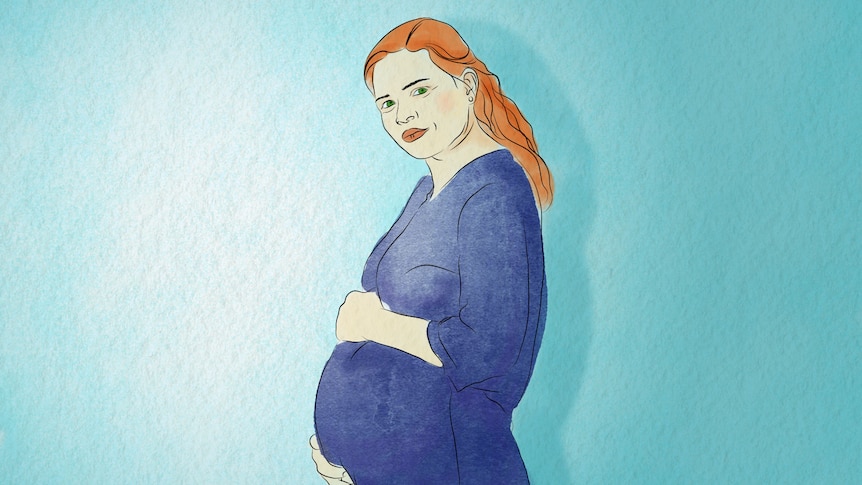 A pregnant woman cradles her belly.