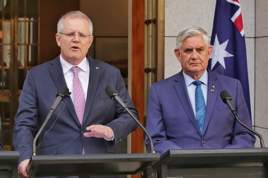 Scott Morrison and Ken Wyatt stand at a podium outside Parliament House.