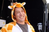 Samuel Johson smiles while wearing his Giraffe onesie