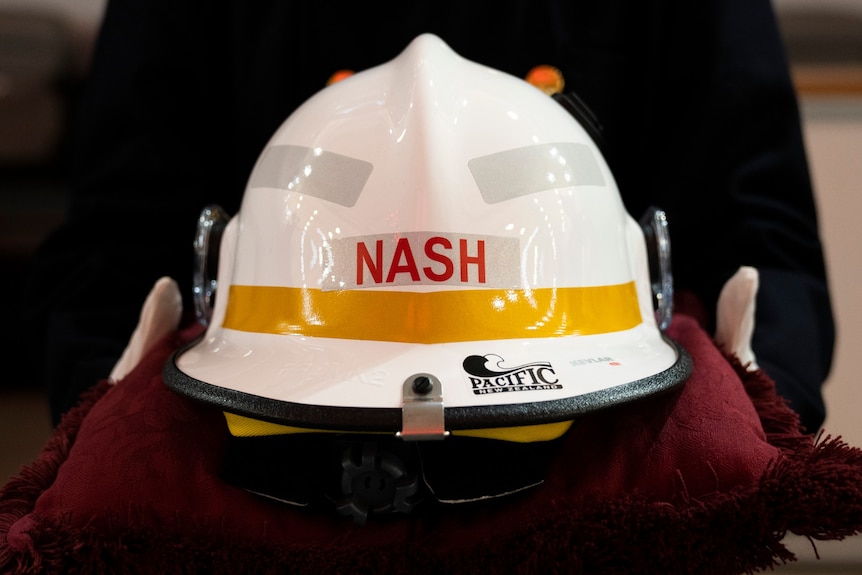 A firefighter helmet reads 'Nash'