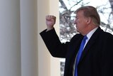 Donald Trump holds up his fist.