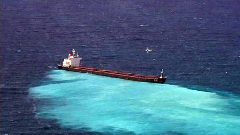 An oil slick spreads from a coal ship which ran aground on Douglas Shoal