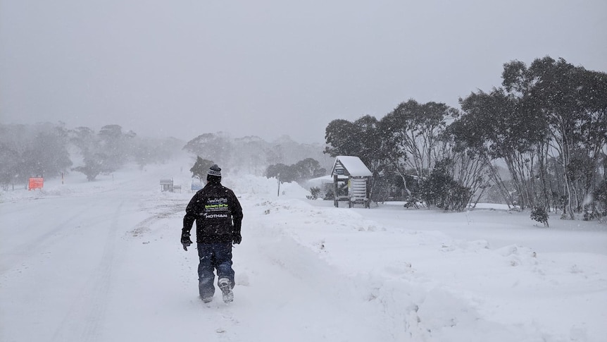 man walking away from camera in snow