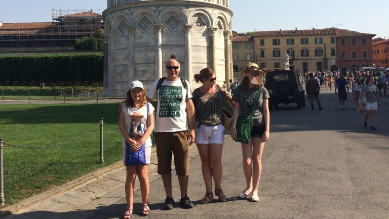 The Greenall family on holiday, standing in front of the Leaning Tower of Pisa.