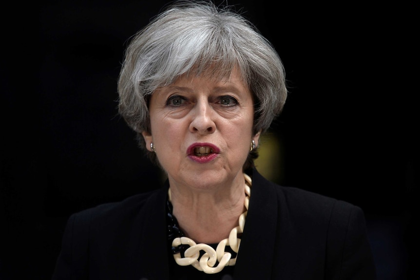 British Prime Minister Theresa May, wearing black, speaks outside 10 Downing Street after a terror attack in London