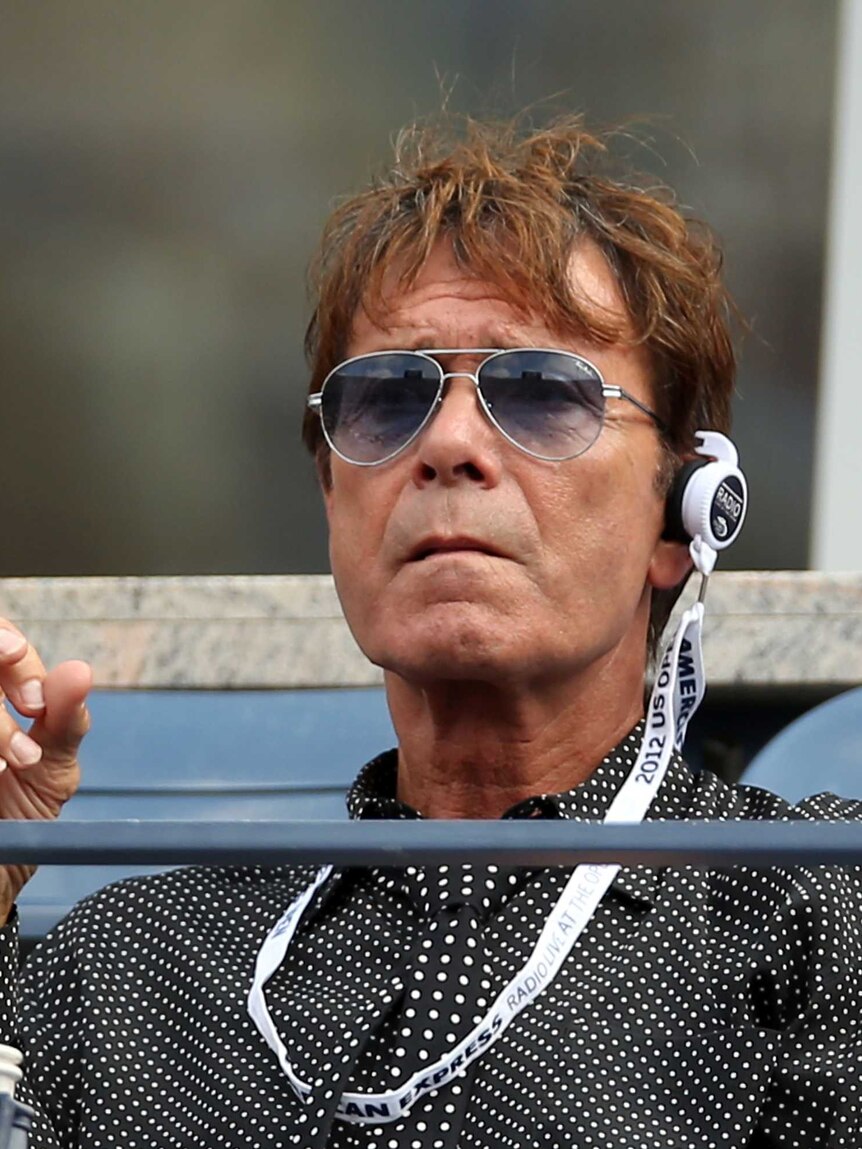 Cliff Richard with sunglasses at tennis tournament