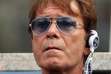 Cliff Richard with sunglasses at tennis tournament