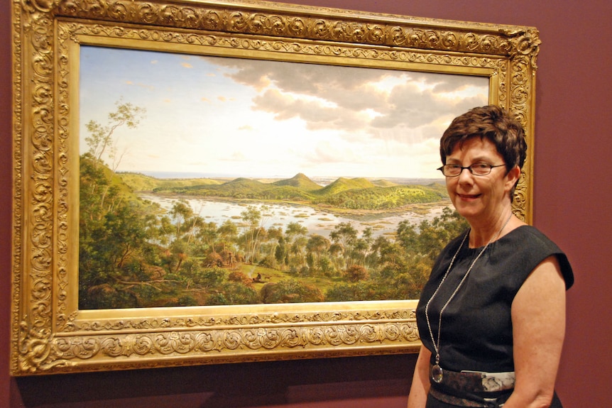 Curator Dr Ruth Pullin admires Eugene von Guerard's painting Tower Hill.