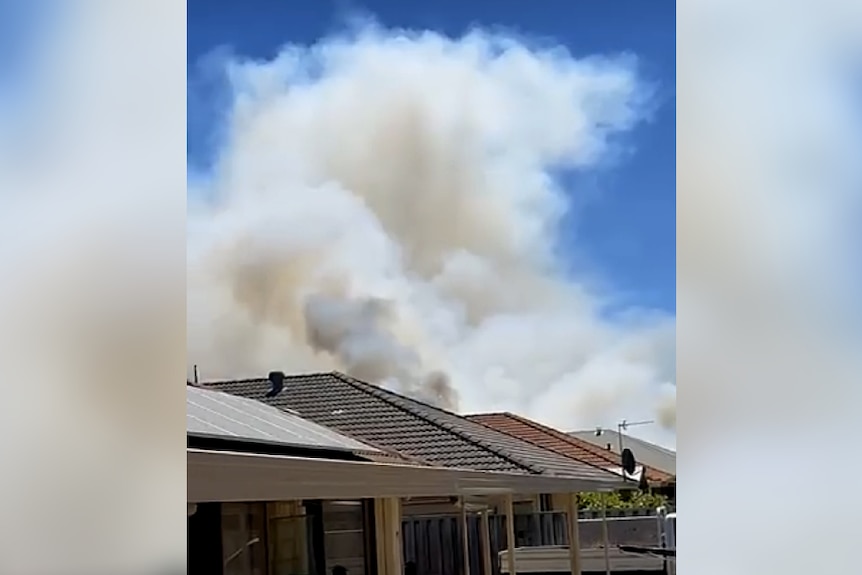 Smoke rises from a suburban house