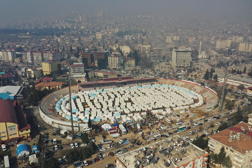 A view from above of tents inside a stadium. 