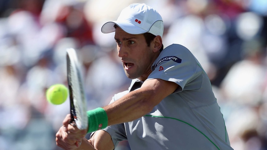 Serbia's Novak Djokovic hits a return against France's Julien Benneteau at Indian Wells.