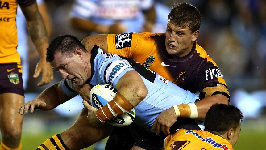 Gritty affair ... Paul Gallen meets the Broncos defence