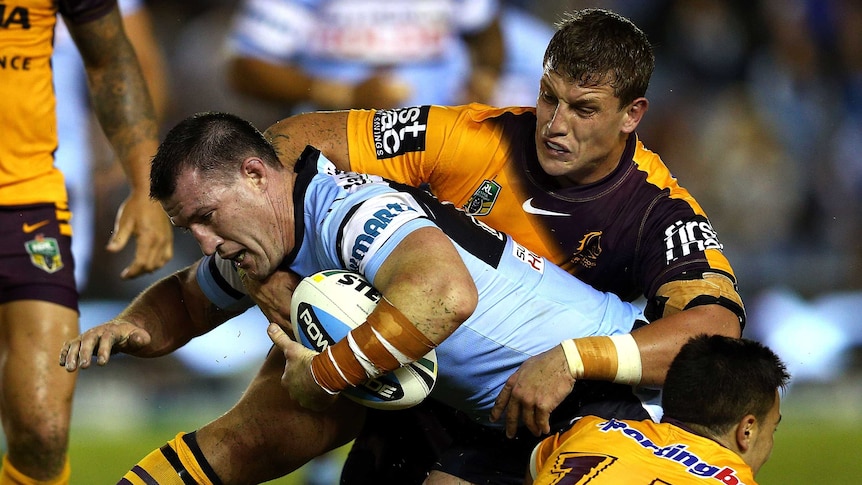 Gritty affair ... Paul Gallen meets the Broncos defence