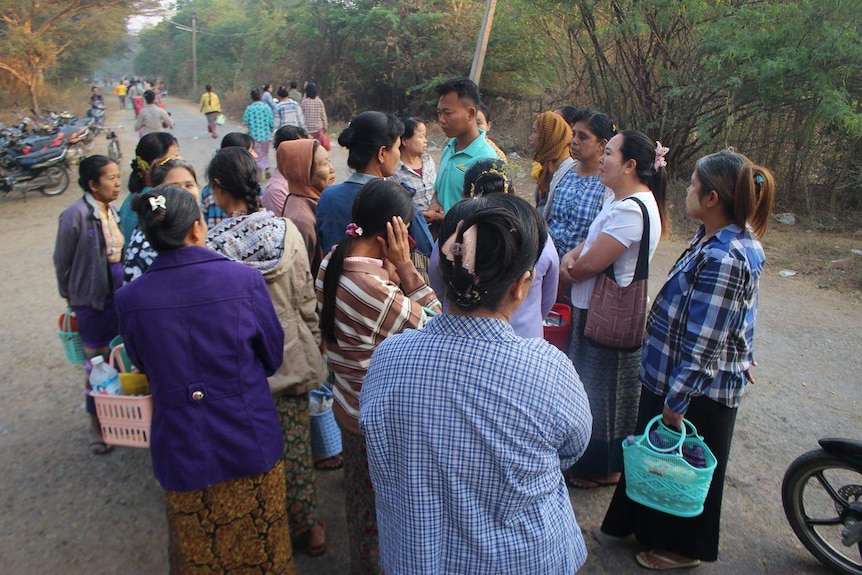 An informal workers meeting organised by one of the union leaders outside a factory in Mandalay.