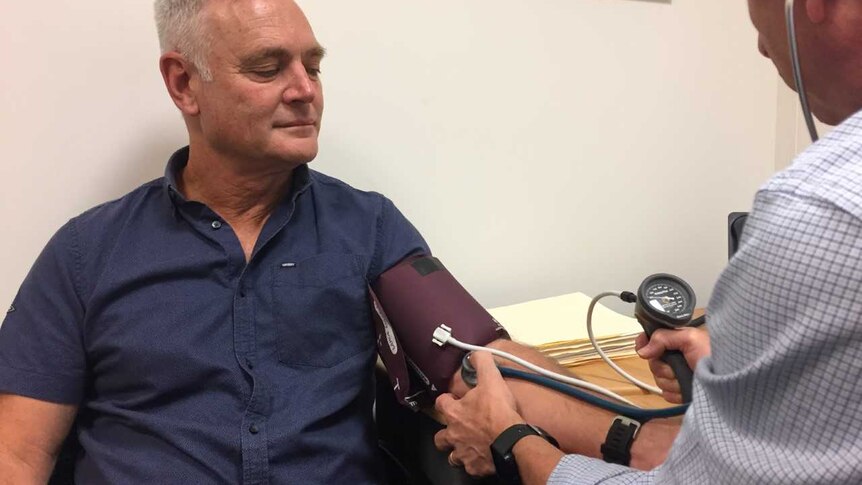 Victorian school principal Glenn Butler having his blood pressure checked.