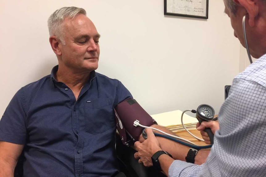 Victorian school principal Glenn Butler having his blood pressure checked.