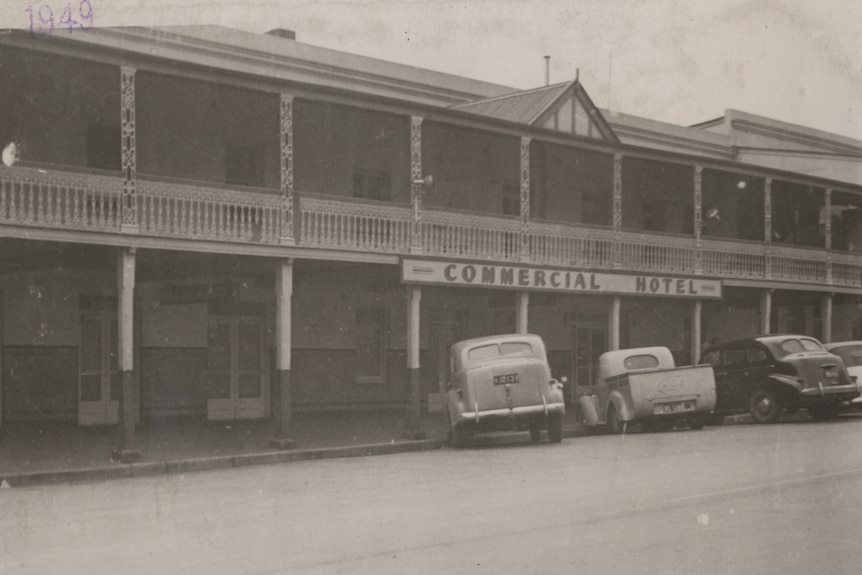 Black and white image of a hotel building with the sign Commerical Hotel. 