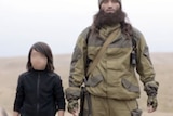 Video posted by Islamic State purports to show the execution of two "Russian spies" by a young boy.