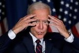 Joe Biden putting his hands on his forehead