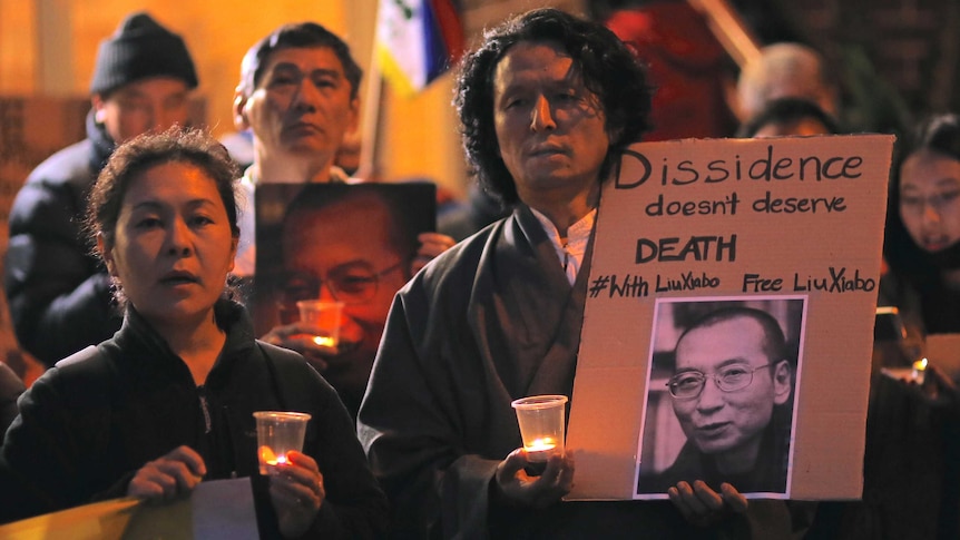 People hold up placards calling for the release of Liu Xiaobo.