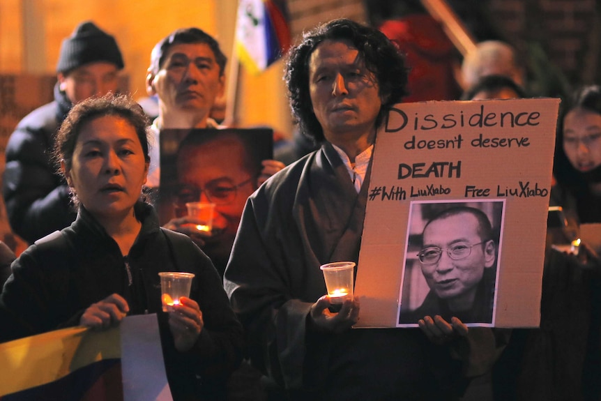 People hold up placards calling for the release of Liu Xiaobo.