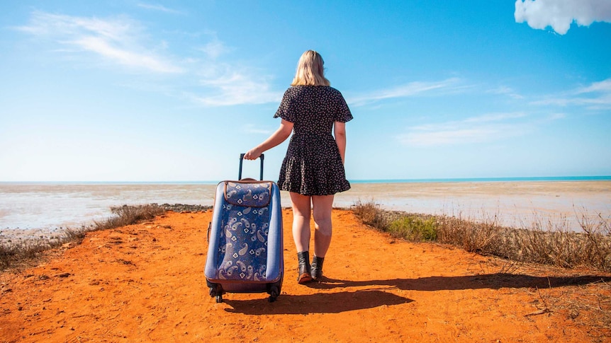 girl walking with a suitcase.