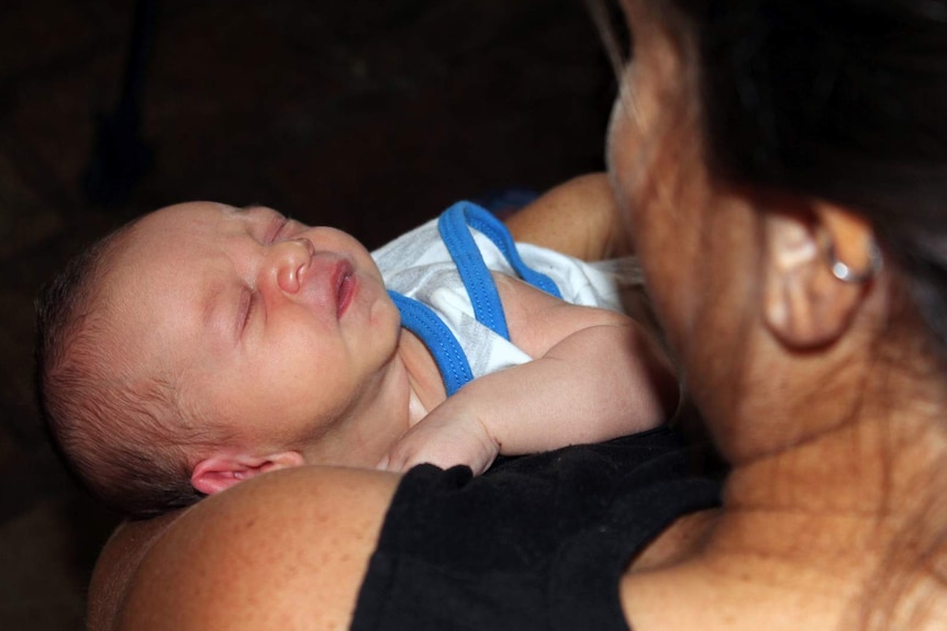 woman holding newborn infant