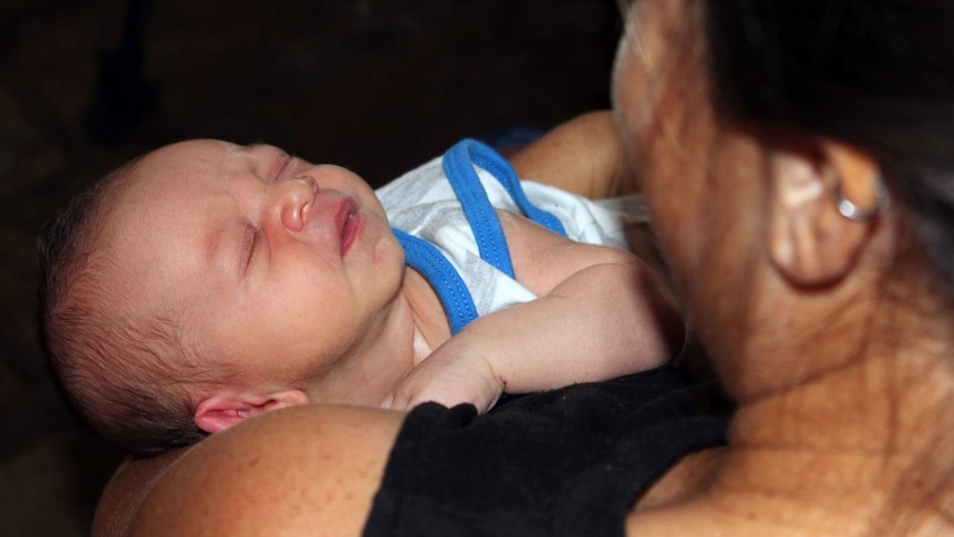 woman holding newborn infant