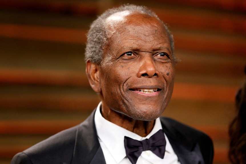 Close up of actor Sidney Poitier in a suit and tie.