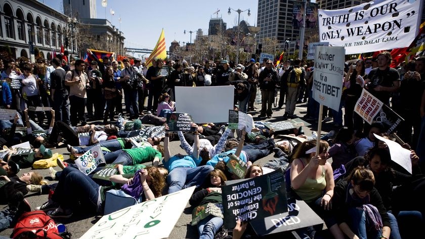 Protesters lie on Embarcadero St in San Francisco, blocking the intended route of the relay.